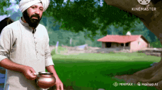 a man in a turban is holding a pot in front of a house