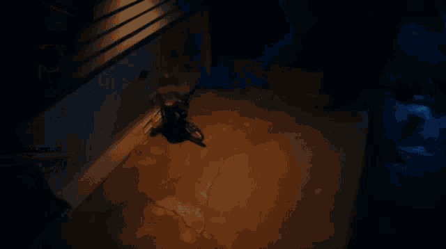 a dark room with a light on the floor