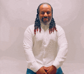 a man with dreadlocks wearing a white shirt