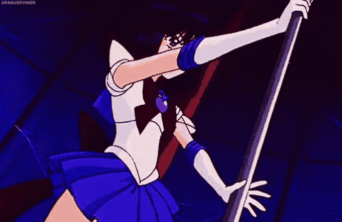 sailor saturn from sailor moon is holding a pole in her hand in a dark room .