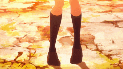 a girl wearing black knee high socks is standing on a concrete floor