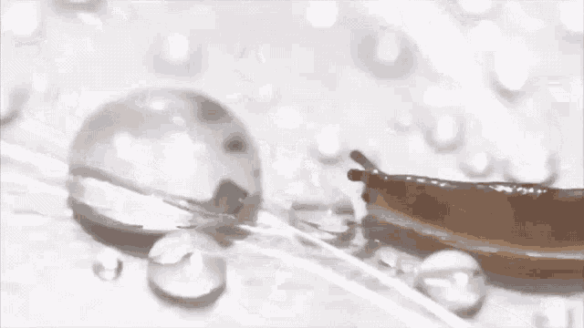a close up of a drop of liquid on a table