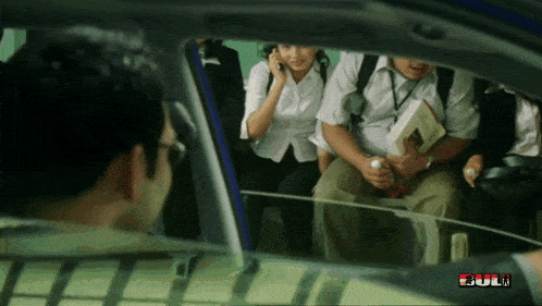 a group of people sitting in a car with the word full on the bottom left