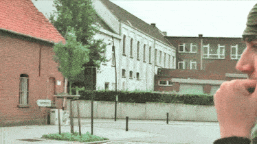 a man talking on a cell phone in front of a building