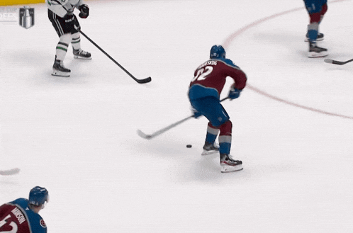 a hockey player with the number 92 on his jersey is flying through the air