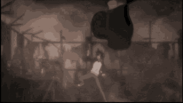 a black and white photo of a man standing in a room with a basketball hoop in the background .