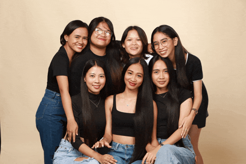 a group of young women pose for a picture together
