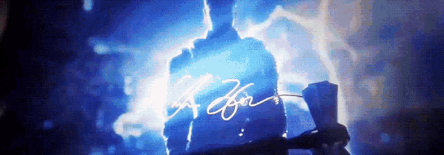 a man is standing in front of a blue light with the word a for written in white