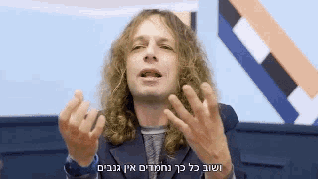 a man with long curly hair is making a funny face