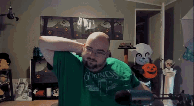 a bald man wearing a green guinness shirt