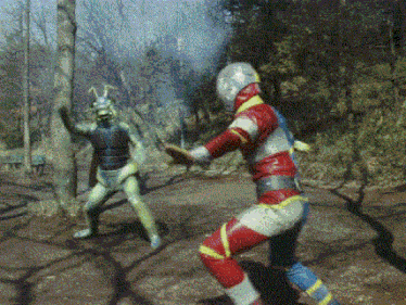 two superheros are fighting each other in the woods