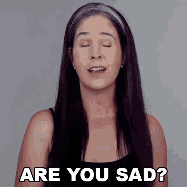 a woman with long dark hair is asking if she is sad