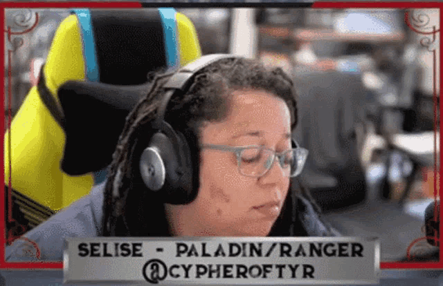 a woman wearing headphones and glasses is sitting in a yellow chair ..