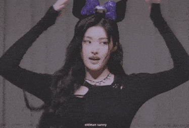 a woman wearing a headband with a purple bow and the name oldman sunny below her
