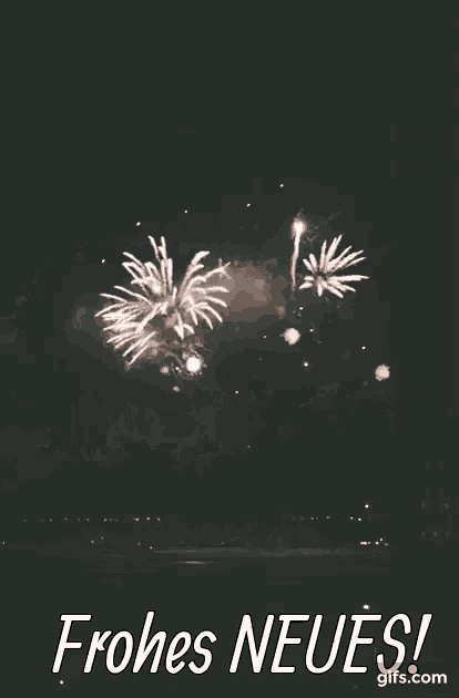 a fireworks display with the words frohes neues written below it
