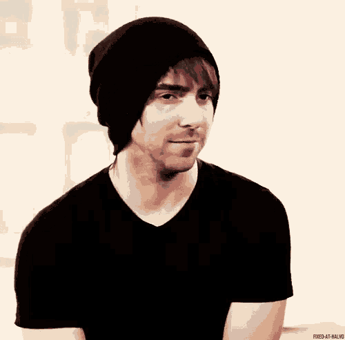 a man wearing a black beanie and a black shirt with the caption fixed at half