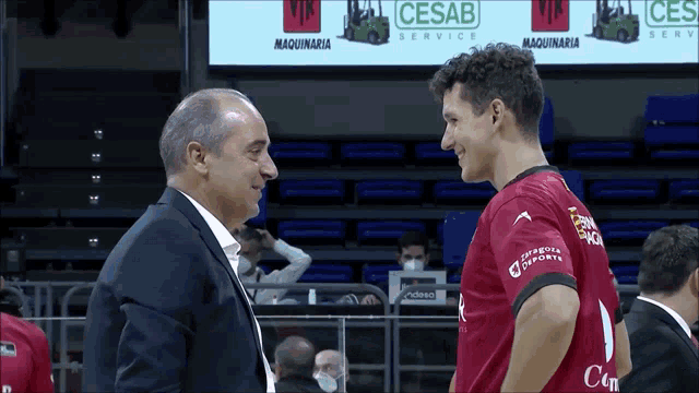two men are standing next to each other in front of a cesab service advertisement