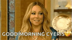 a woman is smiling and saying `` good morning cyeris '' .