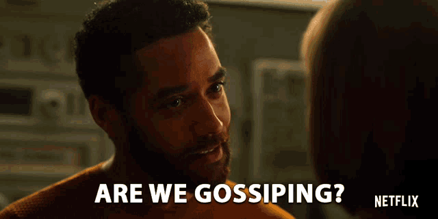 a man talking to another man with the words are we gossiping written below him