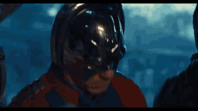 a man in a superhero costume with a helmet on his head
