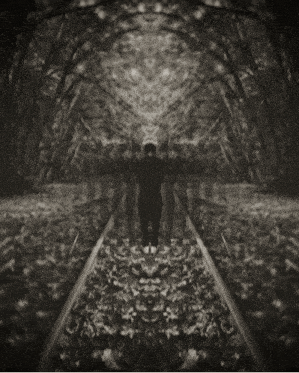 a black and white photo of a person walking down train tracks