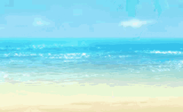 a man in a white shirt stands on a beach looking at the ocean