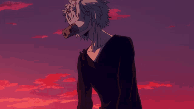 a man with a mask on his face is standing in front of a pink and purple sky