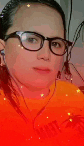 a woman wearing glasses and an orange shirt with the words thank you on it