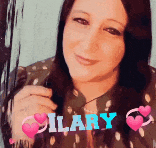 a woman is smiling with the name ilary on her chest