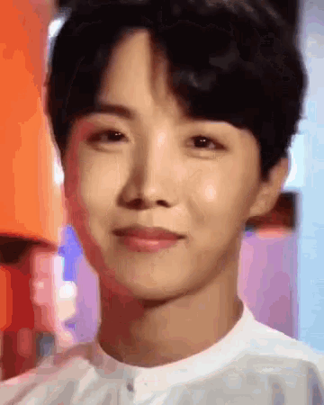 a close up of a young man 's face with a blurred background .