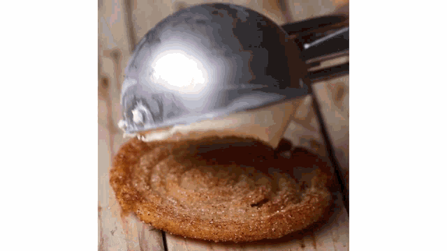 an ice cream scoop is being used to scoop ice cream into a cookie