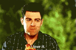 a man in a plaid shirt is eating a slice of pizza and says i love it