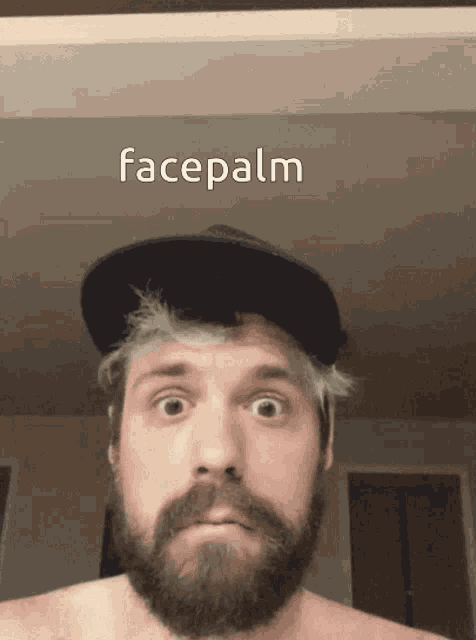 a man with a beard is wearing a hat and has facepalm written on the bottom