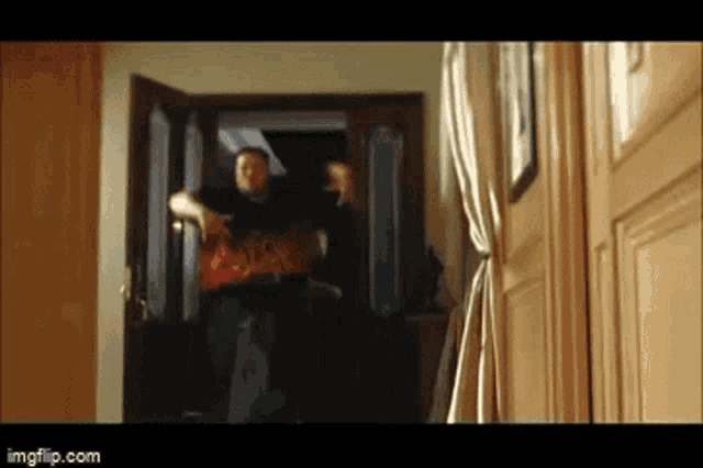 a blurry picture of a man standing in a doorway with imgflip.com in the lower right corner