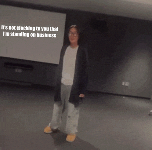 a woman is standing in front of a screen that says it 's not clocking to you that i 'm