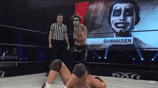 a wrestler named danhausen is in a wrestling ring with another wrestler