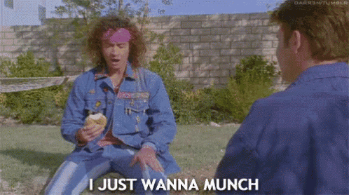 a man in a blue jacket says i just wanna munch while sitting in the grass