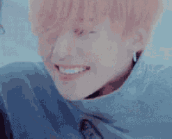 a close up of a person 's face with red hair and a blue shirt .