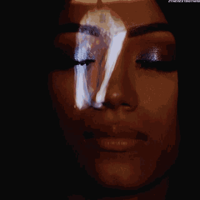 a close up of a woman 's face with the next thing written on the bottom left