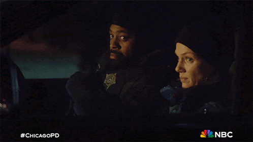 a man and a woman are sitting in a car with #chicagopd on the bottom right