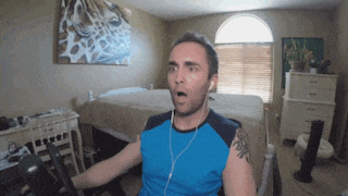a man with a tattoo on his arm is wearing headphones and a blue shirt