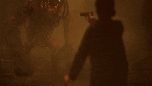 a man is holding a torch in a dark room
