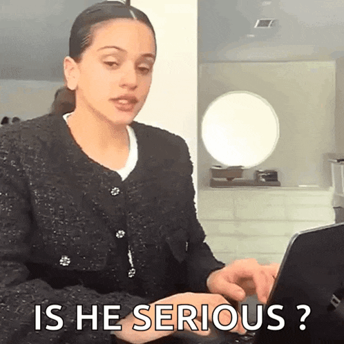 a woman is typing on a laptop computer and asking is he serious ?