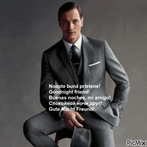 a man in a suit and tie is sitting on a chair