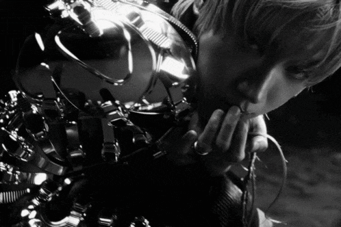 a black and white photo of a person with a ring on their ring finger