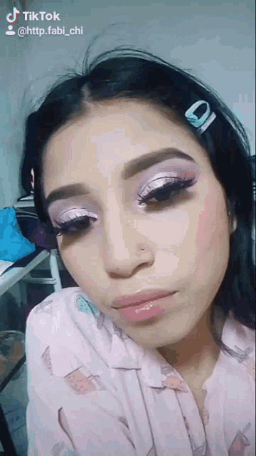 a close up of a woman 's face with a tiktok link