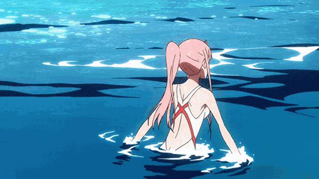 a girl in a red and white swimsuit is swimming in the ocean