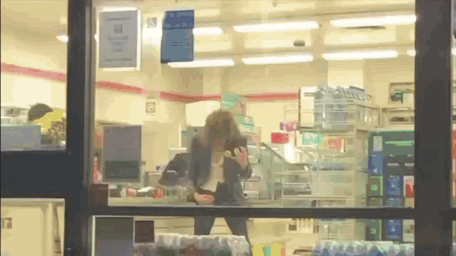 a woman taking a picture of herself in a store