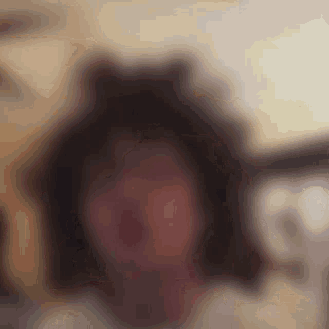 a blurry picture of a person 's face with a cat 's ears