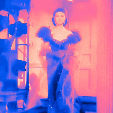 a woman in a long dress is standing in a room